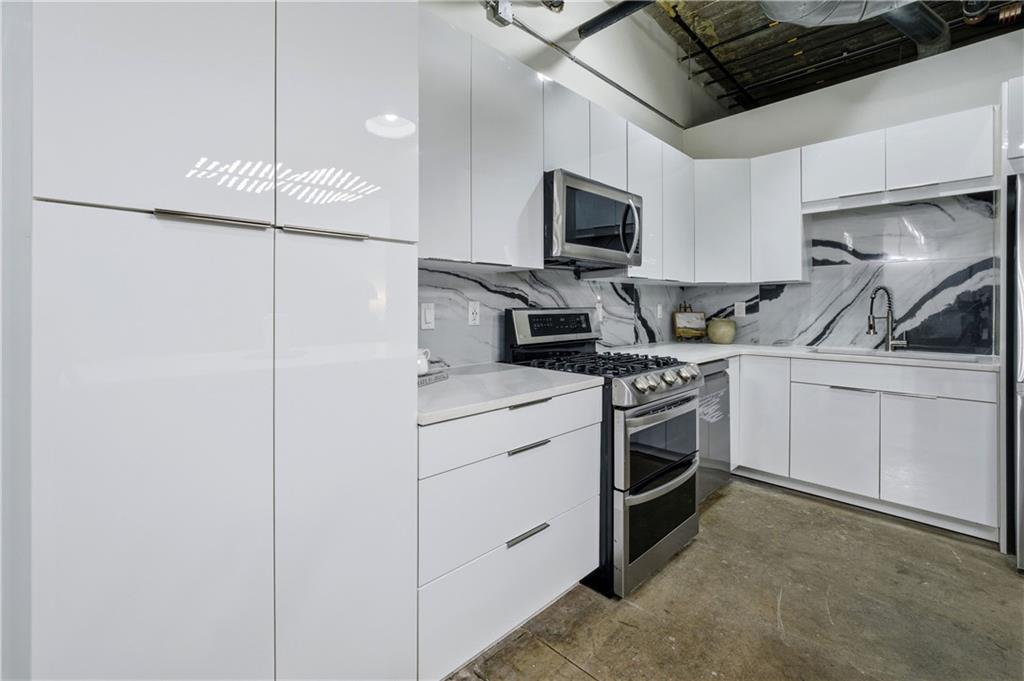 505 Whitehall Street Southwest, Unit 102 Atlanta, GA 30303 - Photo 13 of 46 a kitchen with a sink appliances and cabinets
