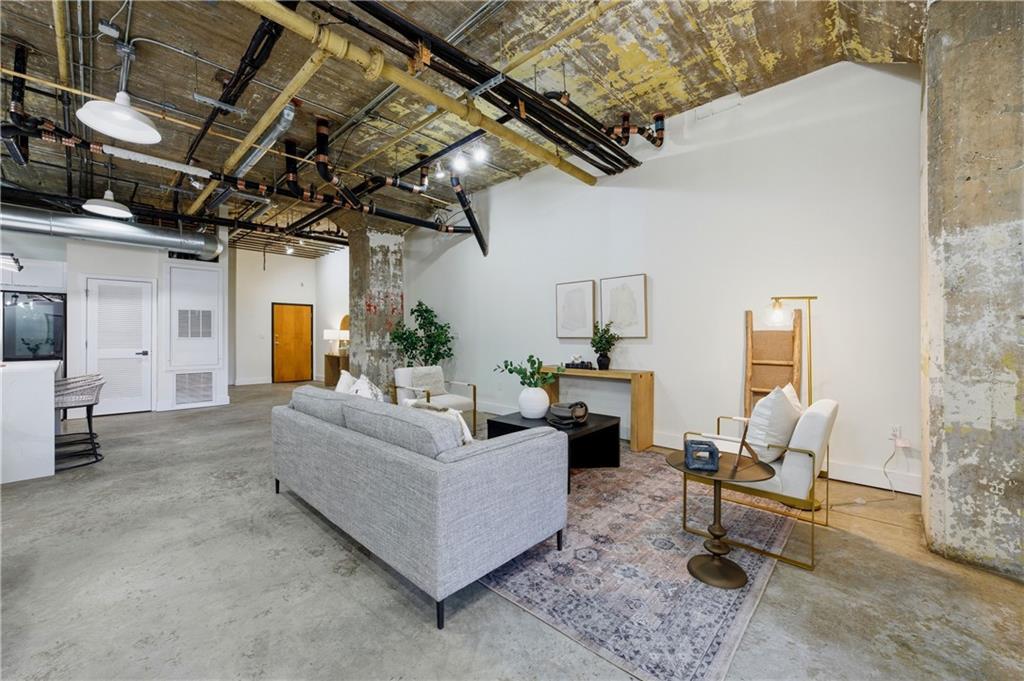 505 Whitehall Street Southwest, Unit 102 Atlanta, GA 30303 - Photo 16 of 46 a living room with furniture and a chandelier