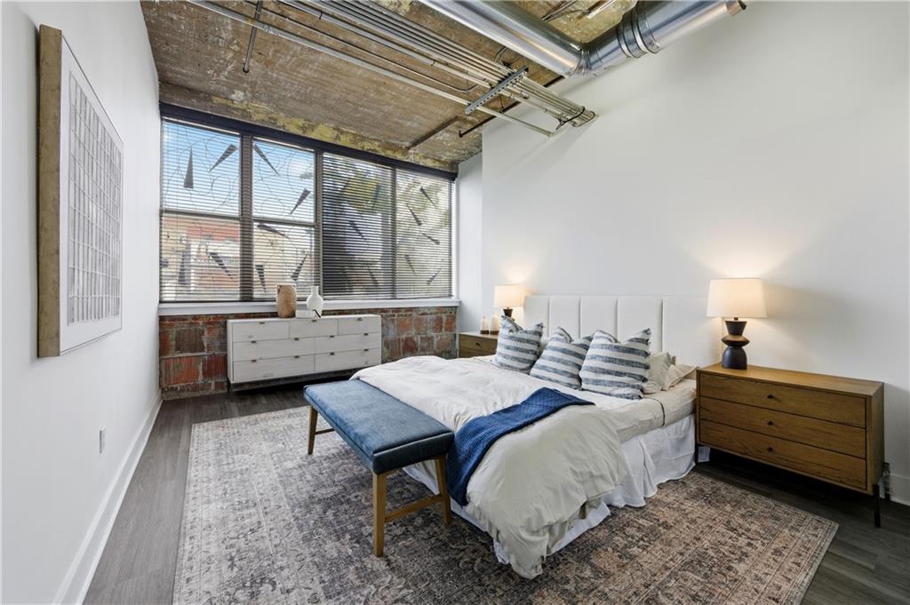 505 Whitehall Street Southwest, Unit 102 Atlanta, GA 30303 - Photo 18 of 46 a bed room with a bed and a table