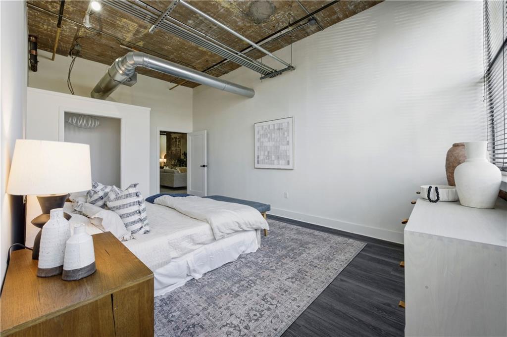 505 Whitehall Street Southwest, Unit 102 Atlanta, GA 30303 - Photo 22 of 46 a bedroom with a bed and wooden floor