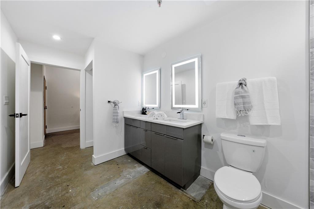 505 Whitehall Street Southwest, Unit 102 Atlanta, GA 30303 - Photo 30 of 46 a bathroom with a toilet a sink and mirror