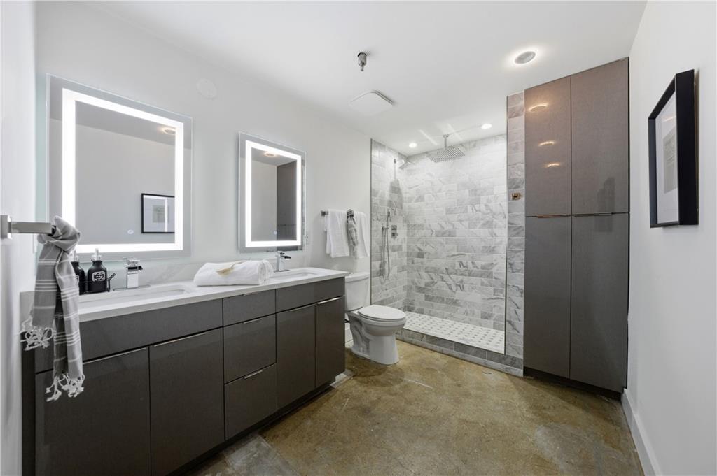 505 Whitehall Street Southwest, Unit 102 Atlanta, GA 30303 - Photo 32 of 46 a bathroom with a double vanity sink toilet mirror and bathtub