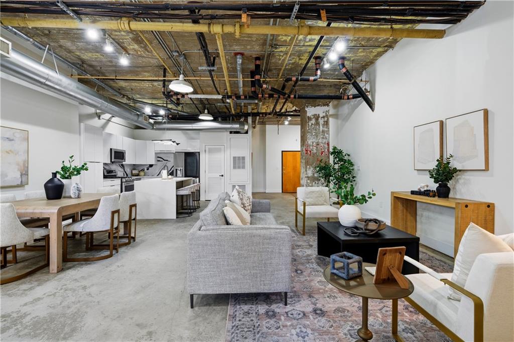 505 Whitehall Street Southwest, Unit 102 Atlanta, GA 30303 - Photo 5 of 46 a living room with furniture and a chandelier