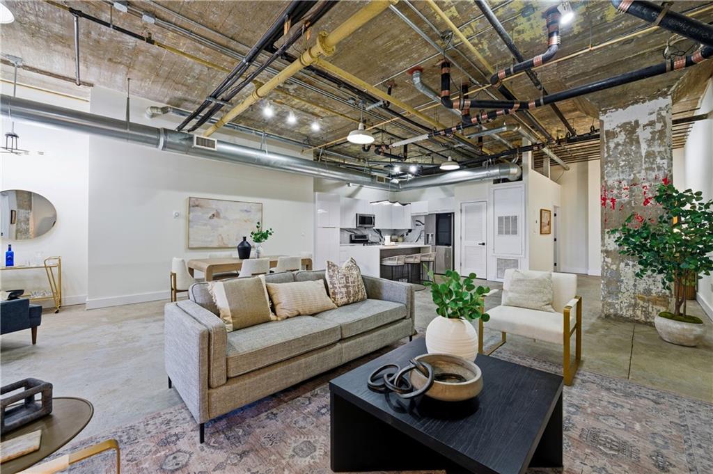 505 Whitehall Street Southwest, Unit 102 Atlanta, GA 30303 - Photo 6 of 46 a living room with furniture and a chandelier