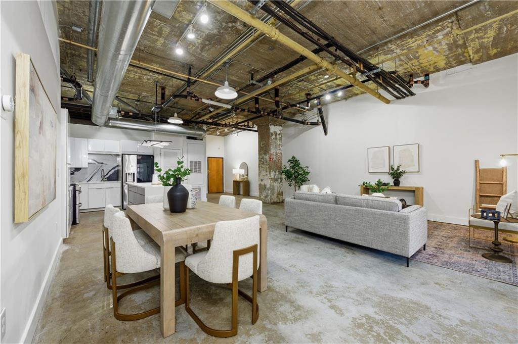 505 Whitehall Street Southwest, Unit 102 Atlanta, GA 30303 - Photo 8 of 46 a dining room with furniture and a kitchen view