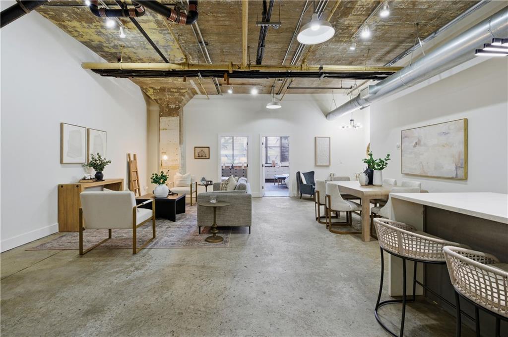 505 Whitehall Street Southwest, Unit 102 Atlanta, GA 30303 - Photo 9 of 46 a living room with lots of furniture and a wooden floor
