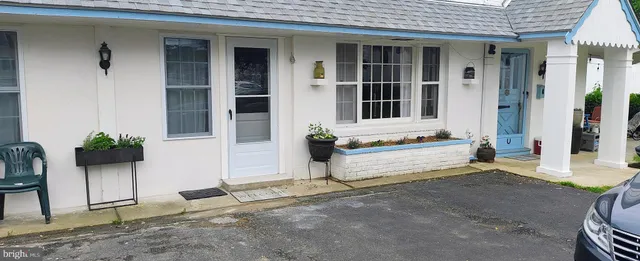 a view of house with outdoor space and glass windows