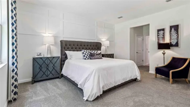 a bedroom with a bed and chair