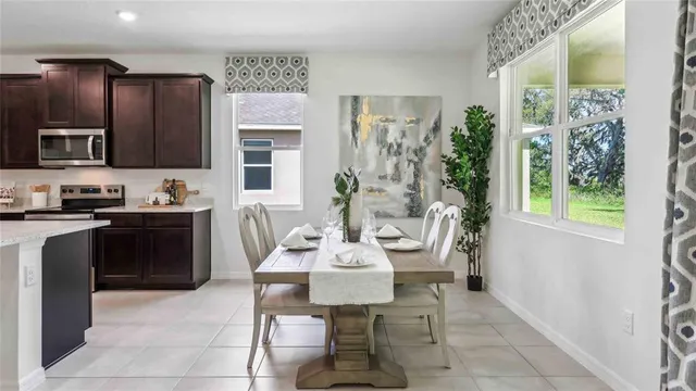 a kitchen with stainless steel appliances kitchen island granite countertop a refrigerator and a stove top oven