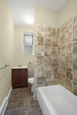 a bathroom with a bathtub and a toilet