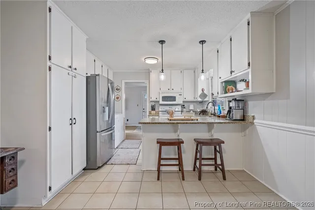 a kitchen with stainless steel appliances a refrigerator sink and cabinets