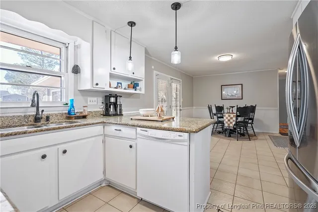 a kitchen with sink cabinets and dining table view