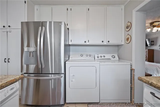 a view of kitchen with refrigerator and stove