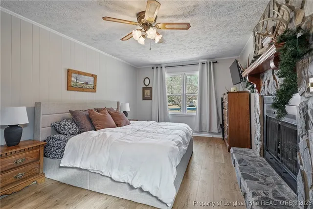 a spacious bedroom with a bed and a chandelier