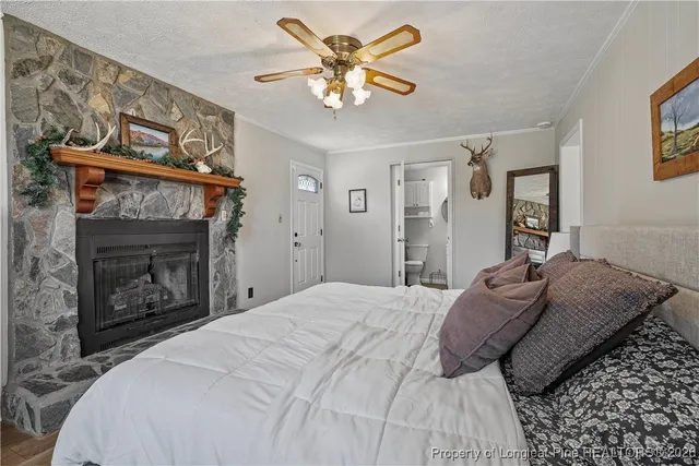 a bedroom with a bed and a fireplace