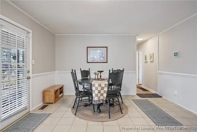 a view of a dining room with furniture and window