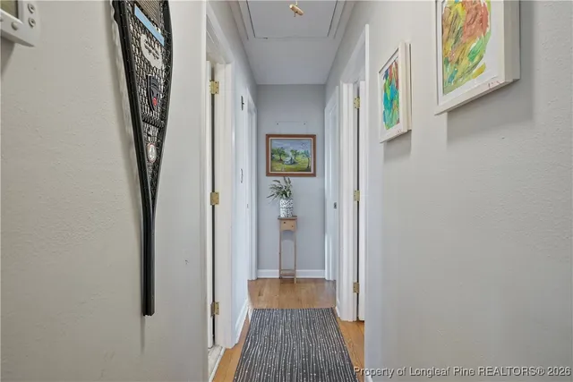 a view of hallway with wooden floor and stairs