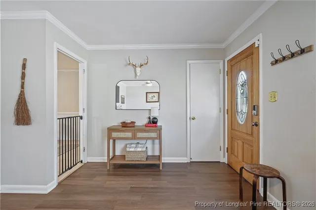 a view of a livingroom with wooden floor and furniture