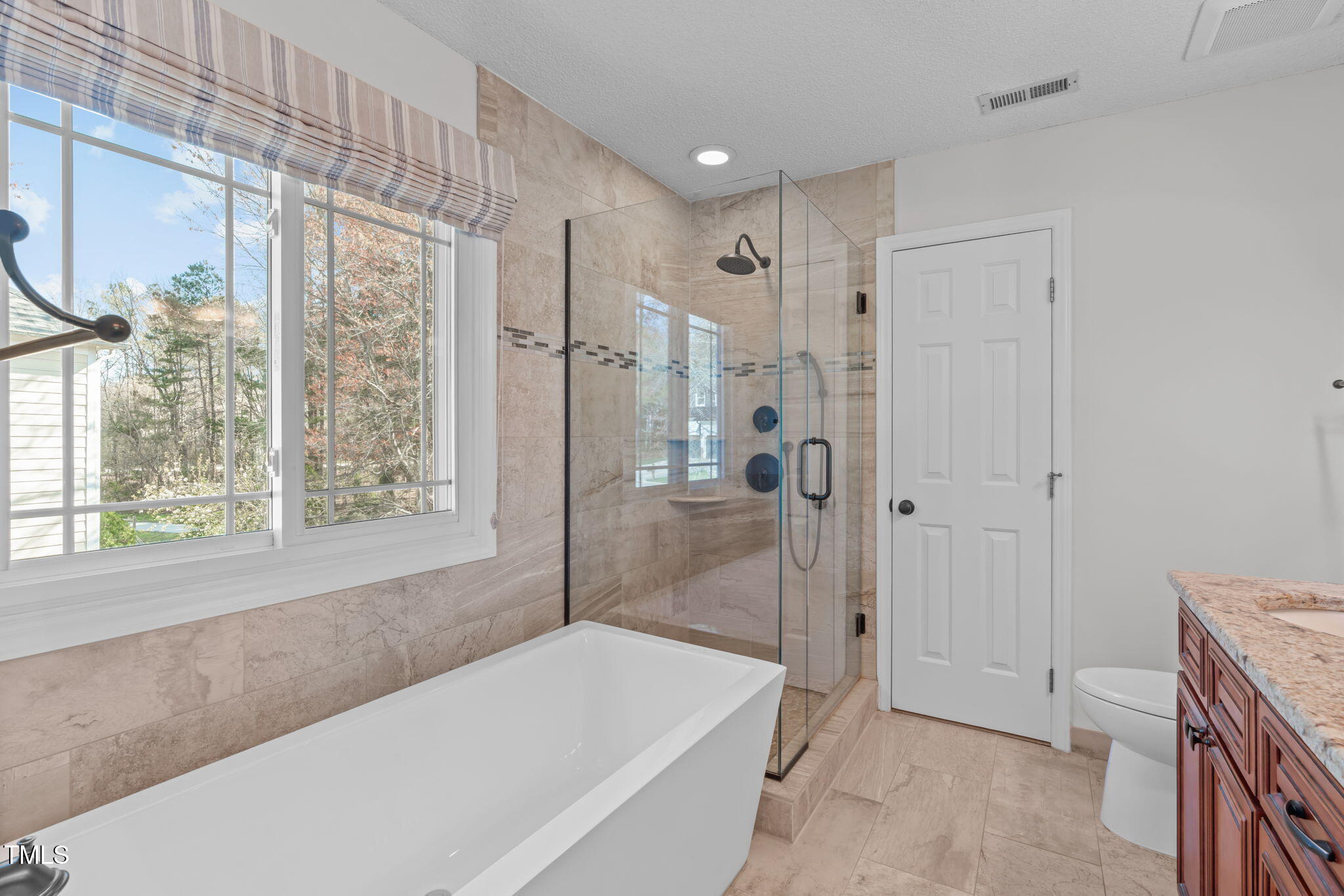 109 Covington Square Drive Cary, NC 27513 - Photo 17 of 41 a spacious bathroom with a granite countertop tub shower and sink