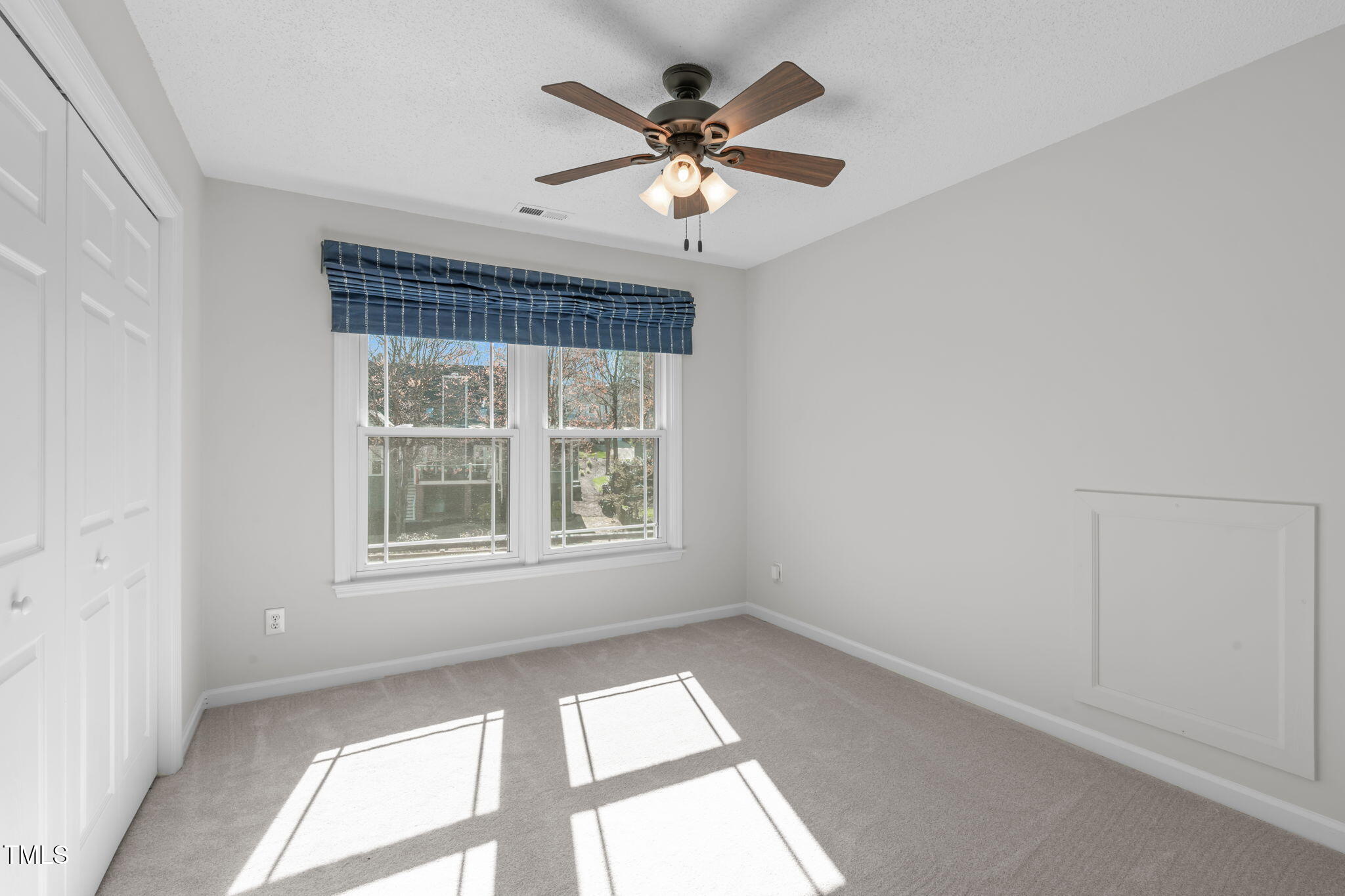 109 Covington Square Drive Cary, NC 27513 - Photo 21 of 41 an empty room with chandelier fan and windows