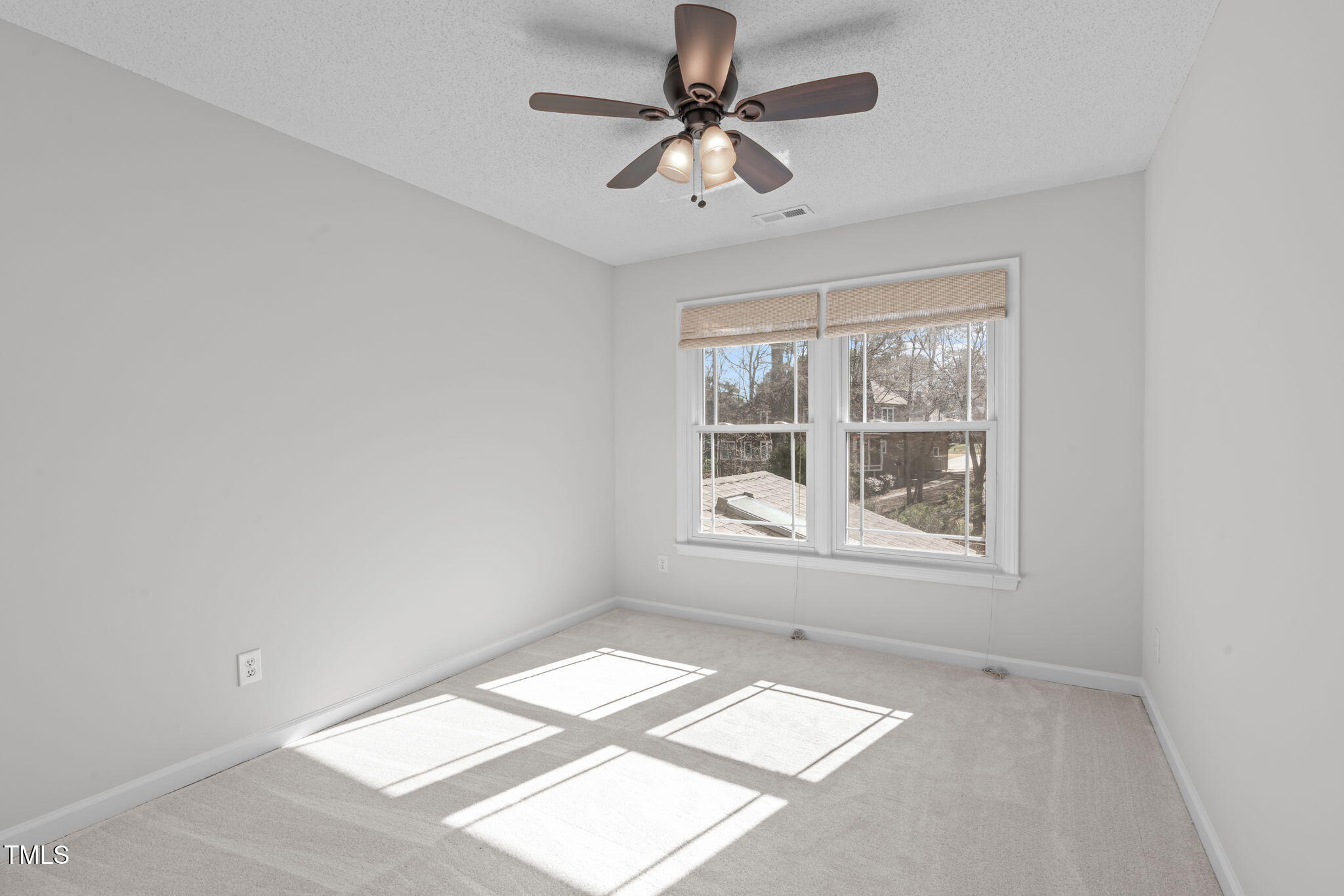 109 Covington Square Drive Cary, NC 27513 - Photo 23 of 41 an empty room with windows and fan