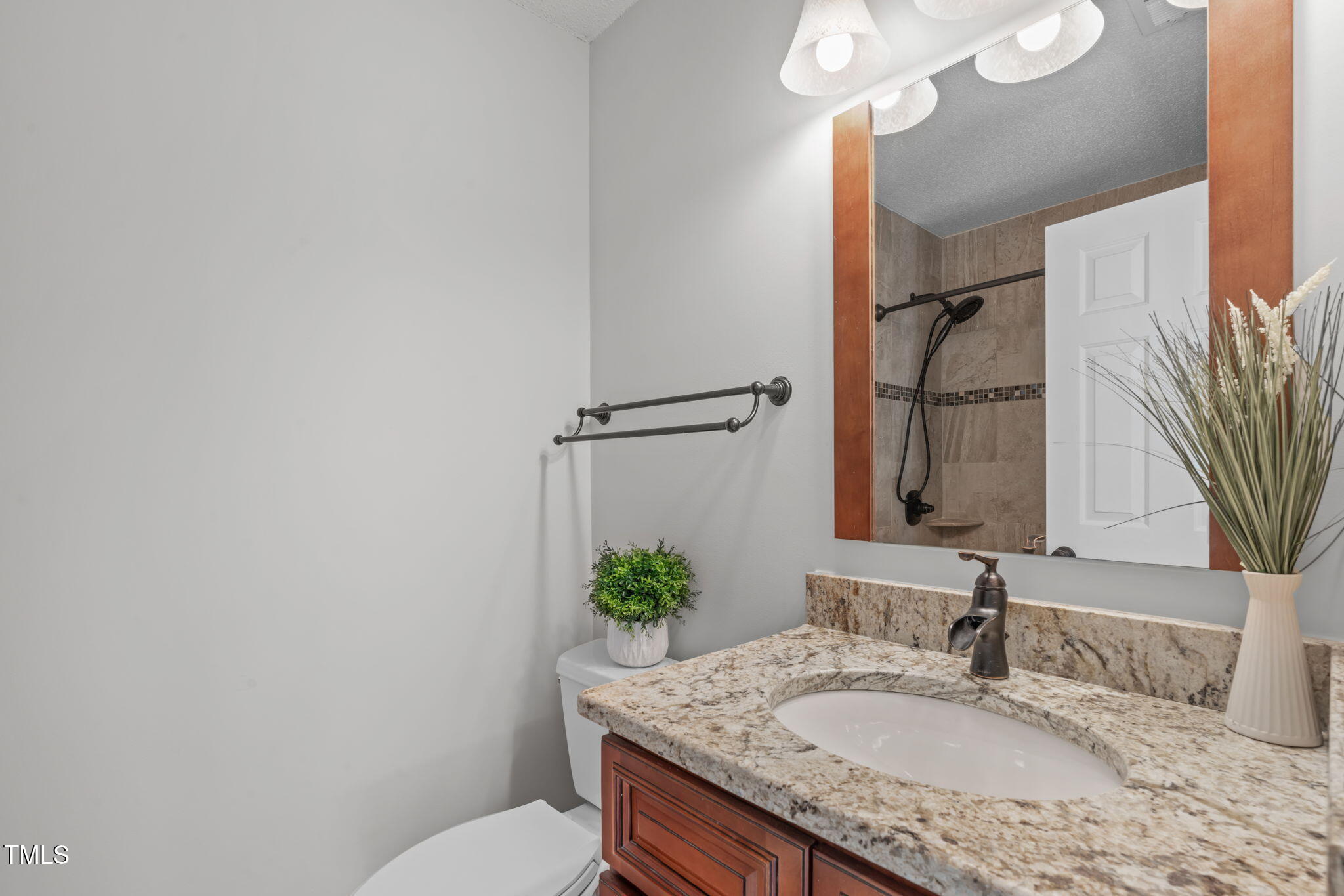 109 Covington Square Drive Cary, NC 27513 - Photo 25 of 41 a bathroom with a granite countertop sink and a mirror