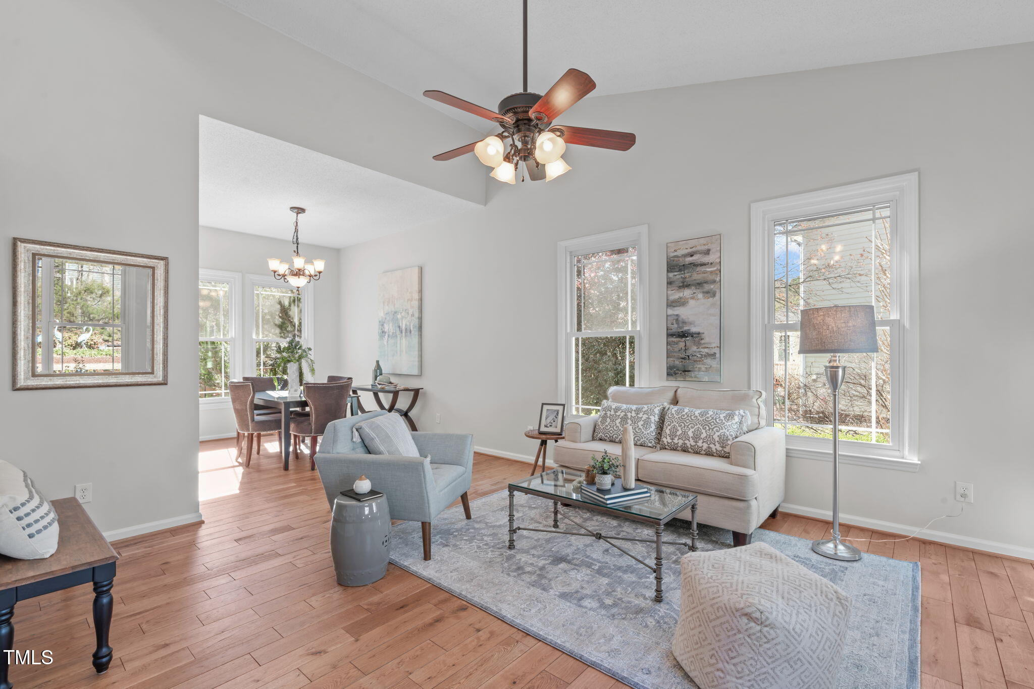 109 Covington Square Drive Cary, NC 27513 - Photo 3 of 41 a living room with furniture a chandelier and a window