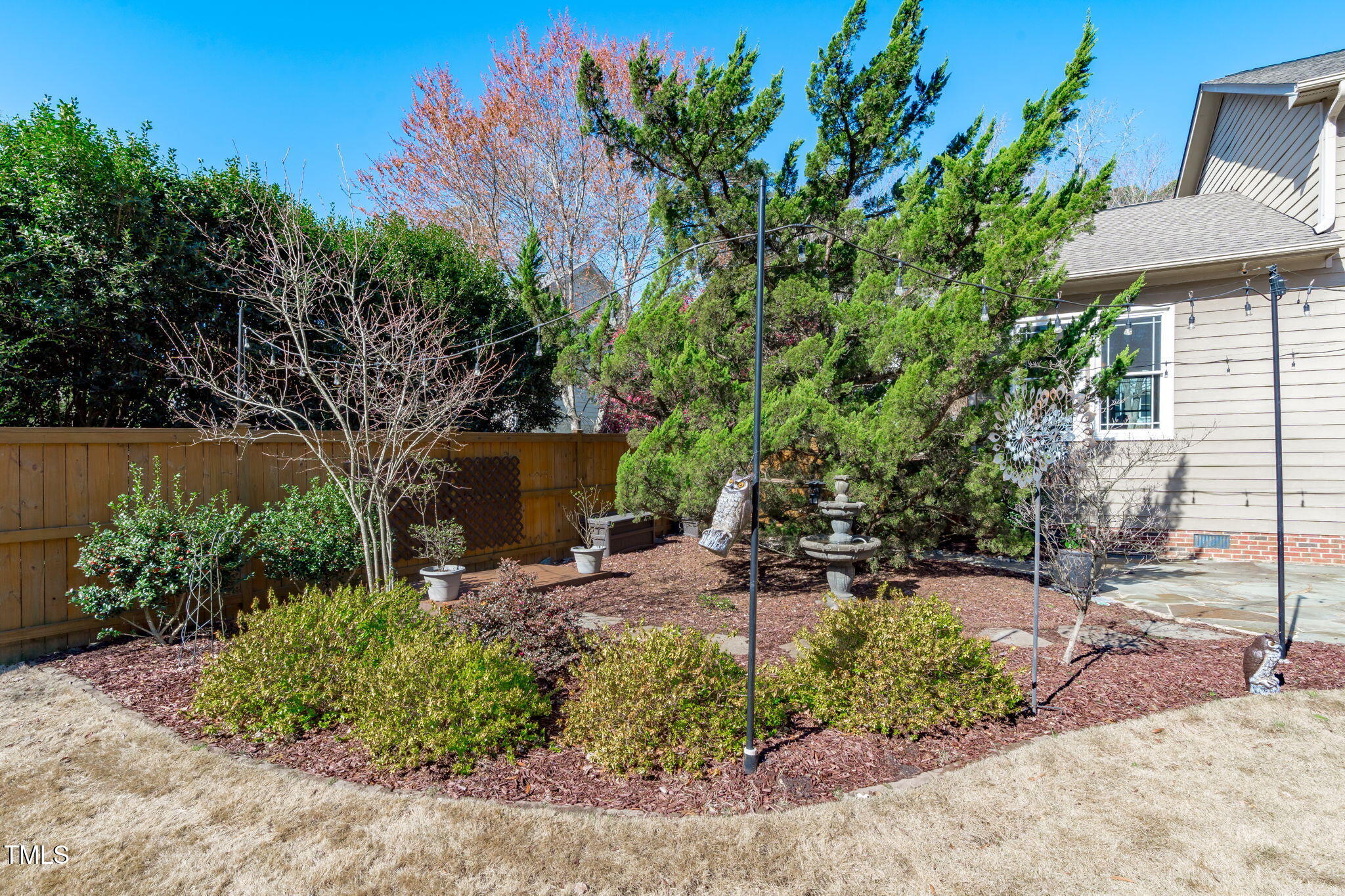 109 Covington Square Drive Cary, NC 27513 - Photo 31 of 41 a view of a backyard with plants and a tree