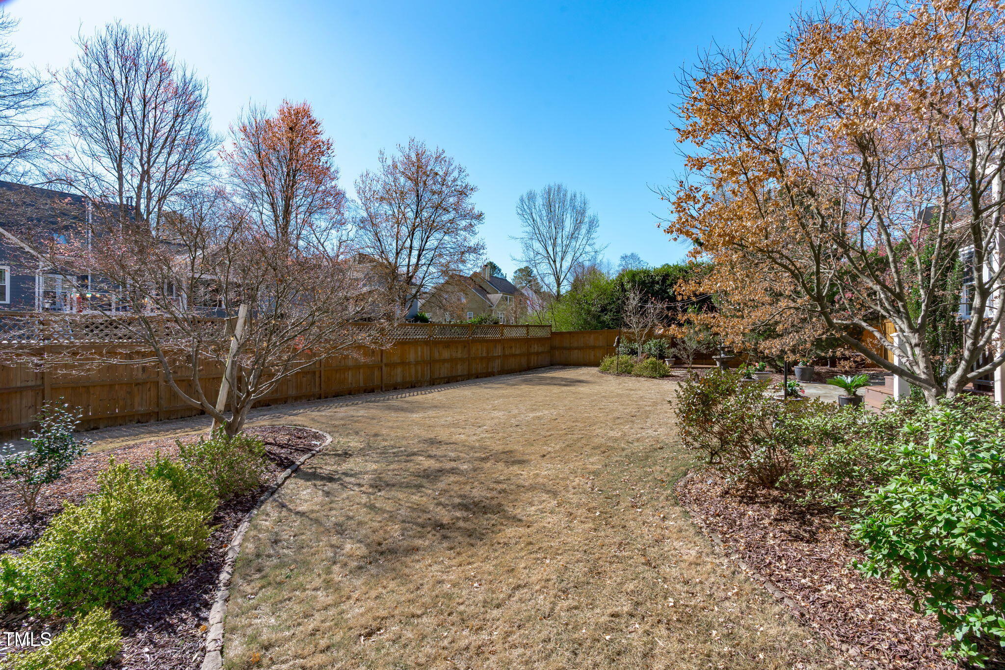 109 Covington Square Drive Cary, NC 27513 - Photo 34 of 41 a view of a yard with plants and a large tree