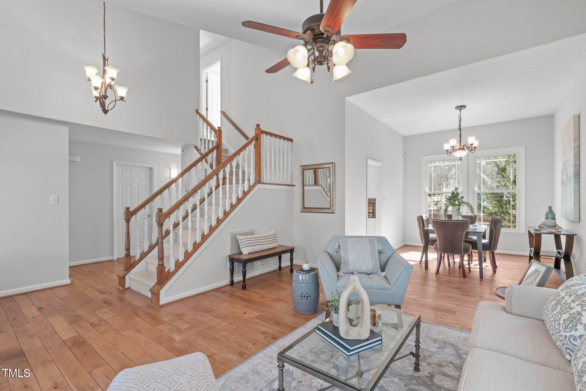 109 Covington Square Drive Cary, NC 27513 - Photo 4 of 41 a living room with furniture and a chandelier