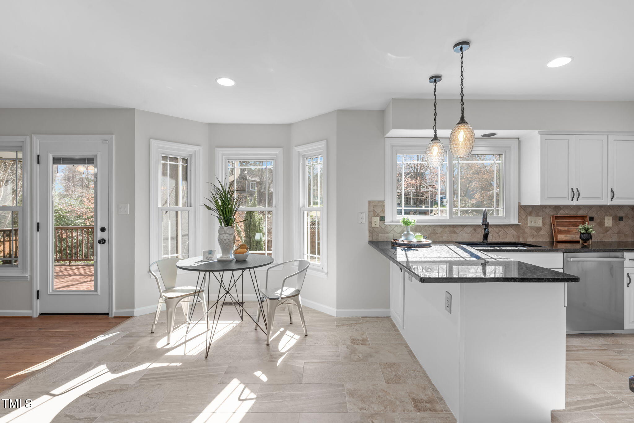 109 Covington Square Drive Cary, NC 27513 - Photo 7 of 41 a kitchen with stainless steel appliances granite countertop a stove a sink a dining table and chairs