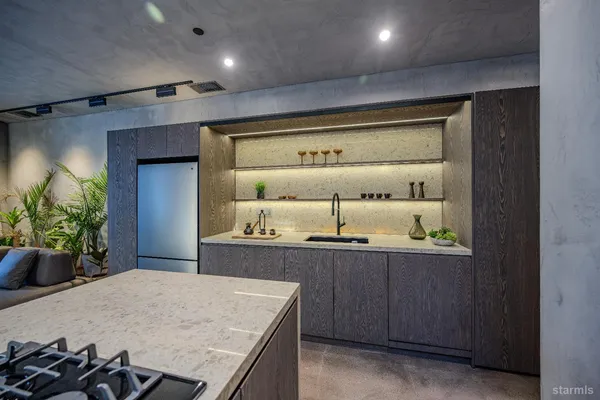 a kitchen with kitchen island a stove a sink and a refrigerator