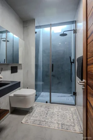 a bathroom with a toilet and a shower