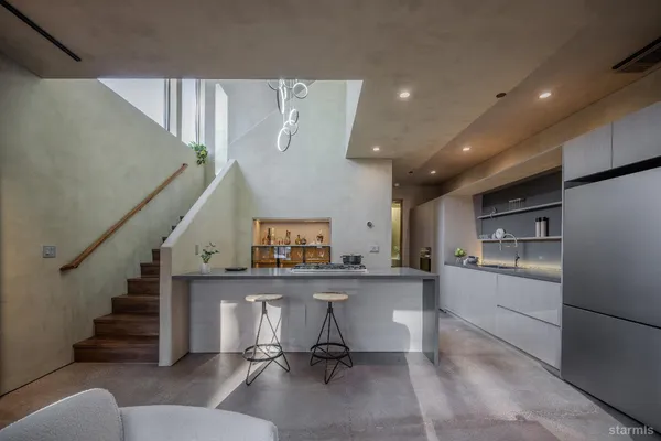 a view of a livingroom with stairs and furniture