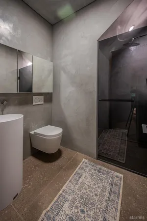 a bathroom with a toilet and a shower