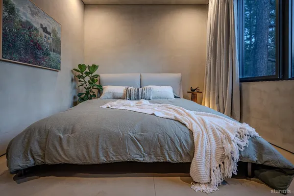 a bedroom with a bed and a potted plant