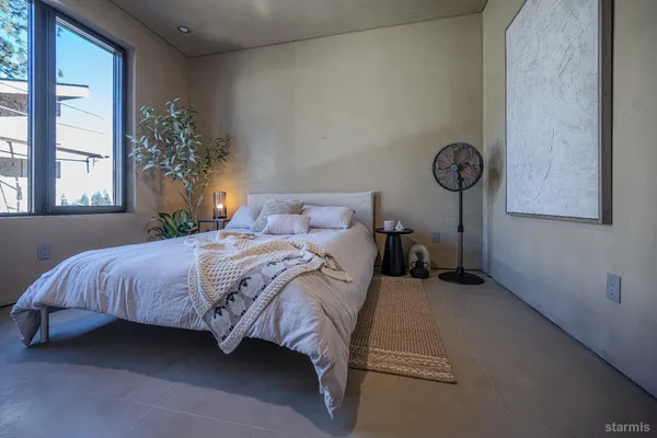 a bedroom with a bed and a window