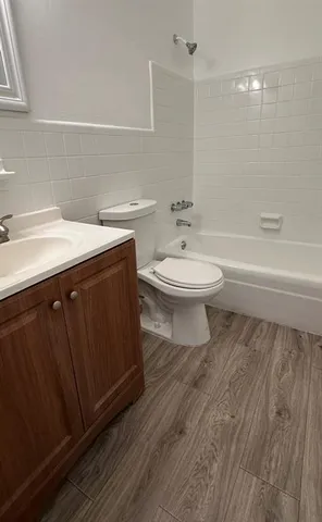 a bathroom with a toilet a sink and bathtub