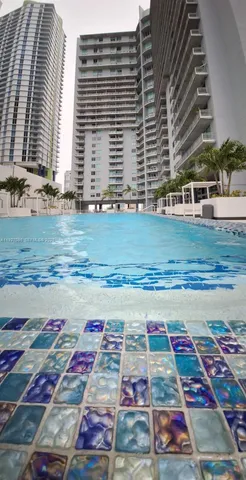 a view of a swimming pool with outdoor seating
