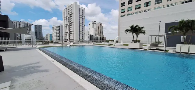 a living room filled with furniture and floor to ceiling window