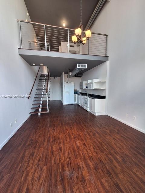 690 Southwest 1st Court, Unit 2711 Miami, FL 33130 - Photo 2 of 26 a hallway with wooden floors and staircase