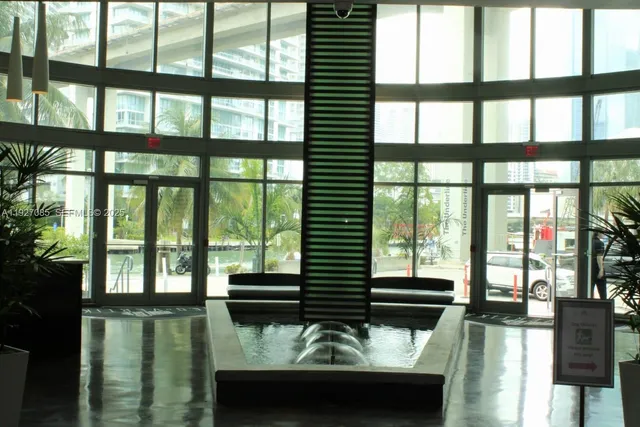 a kitchen with stainless steel appliances wooden floor and a table