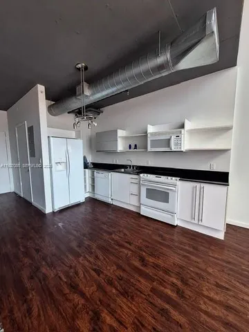 a view of a livingroom with wooden floor