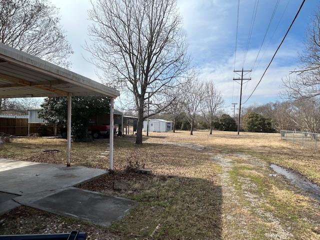 401 South Carter Street Whitewright, TX 75491 - Photo 3 of 5 a view of a yard with a tree