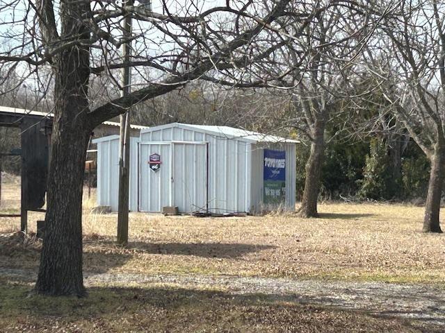 401 South Carter Street Whitewright, TX 75491 - Photo 4 of 5 a view of a house with snow in the yard