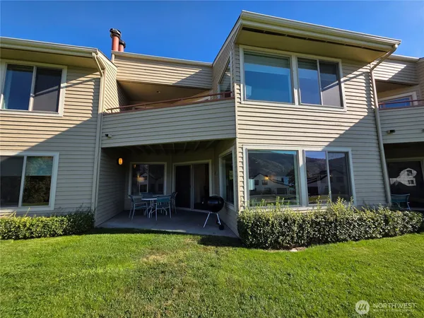 a view of a backyard with chairs and a fire pit