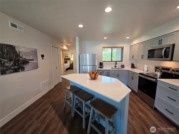 a bedroom with a bed and lamp on table