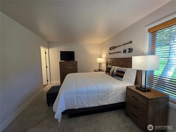 a bathroom with a sink a toilet a mirror and shower