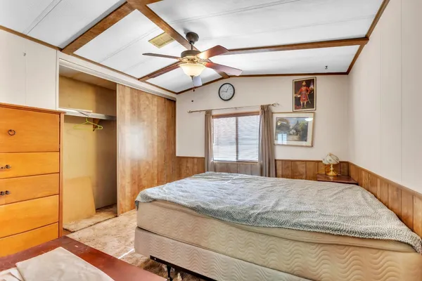 a bedroom with a bed and a window