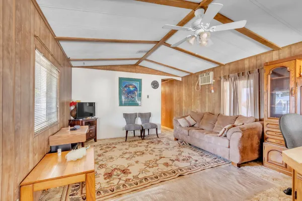 a living room with furniture window and a flat screen tv